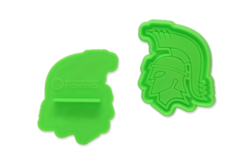 Bright green cookie cutter press (cutter), showing back and front.
